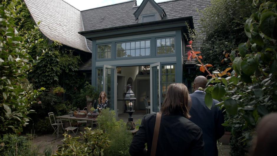 Irene McAllistair stands up while Quentin, Dean Fogg, and Julia approach.