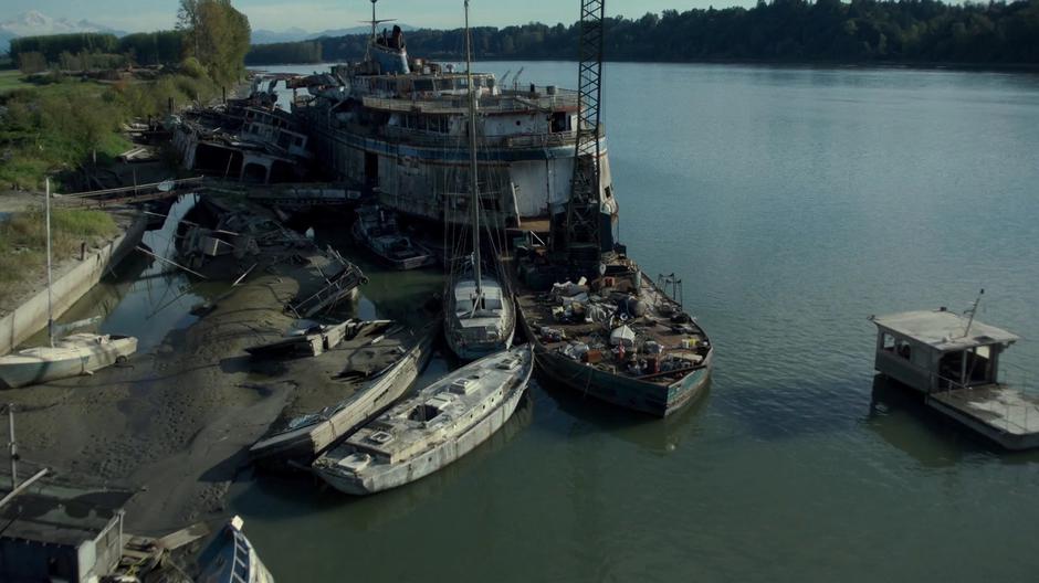 The Chimera sits at the shore among a whole group of abandoned boats.