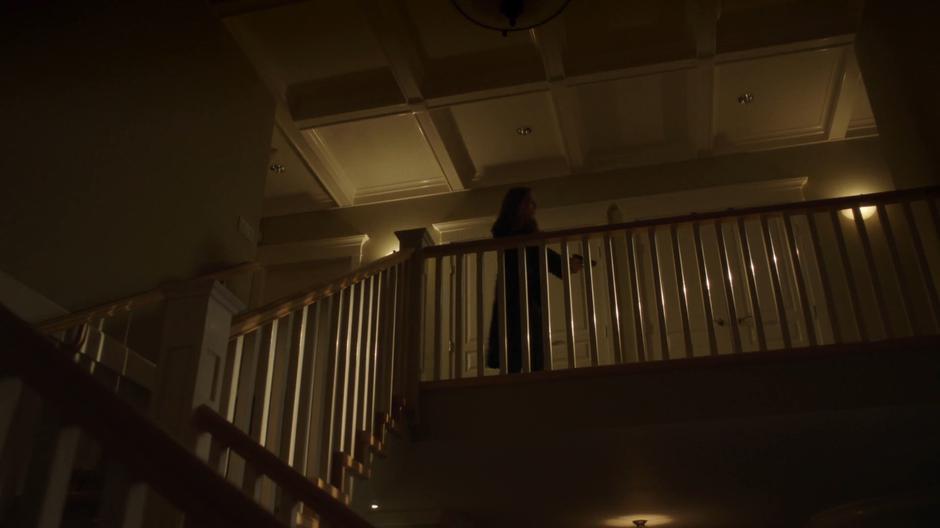 Scully searches the upper floor of the house.