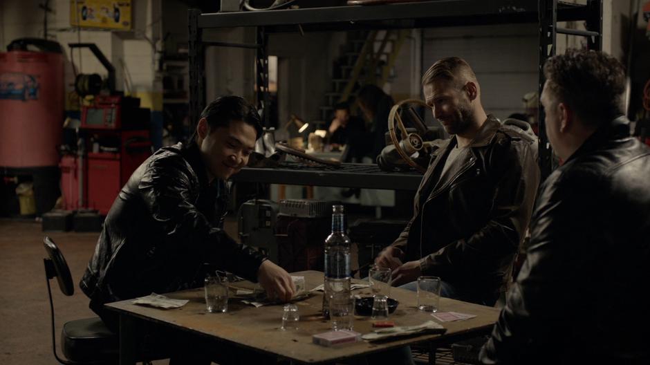 Vincent plays cards with a couple of guys while undercover.