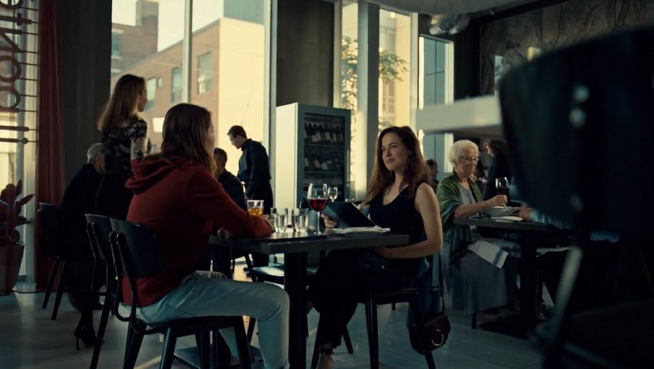 Jess and Mary sit in the restaurant and Mary looks at the menu.