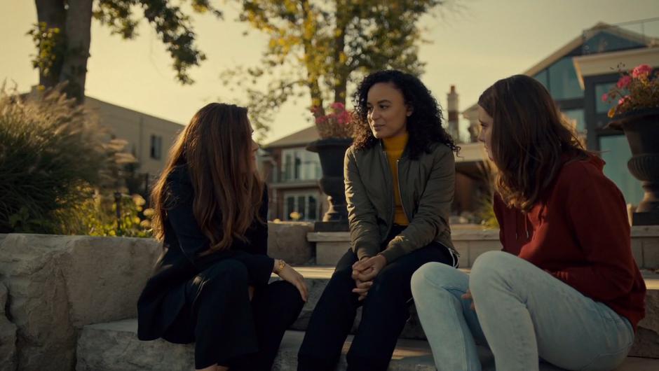 Mary sits down next to Heather and Jess in the back yard to talk.