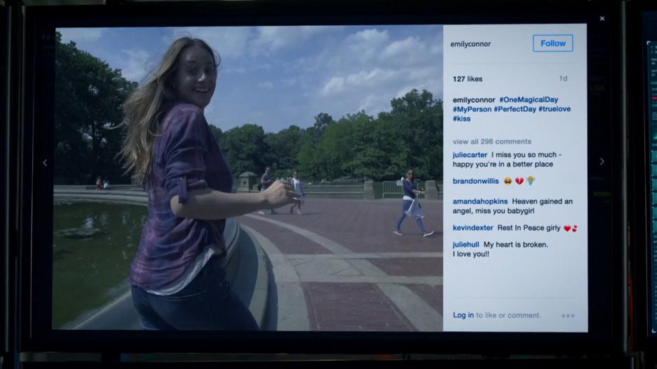 Emily Connor turns back at the camera as she walks along beside the fountain.