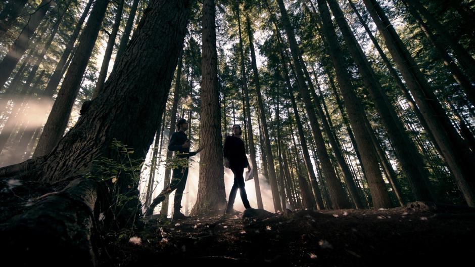 Eliot and Quentin exit the portal into the woods on Fillory.