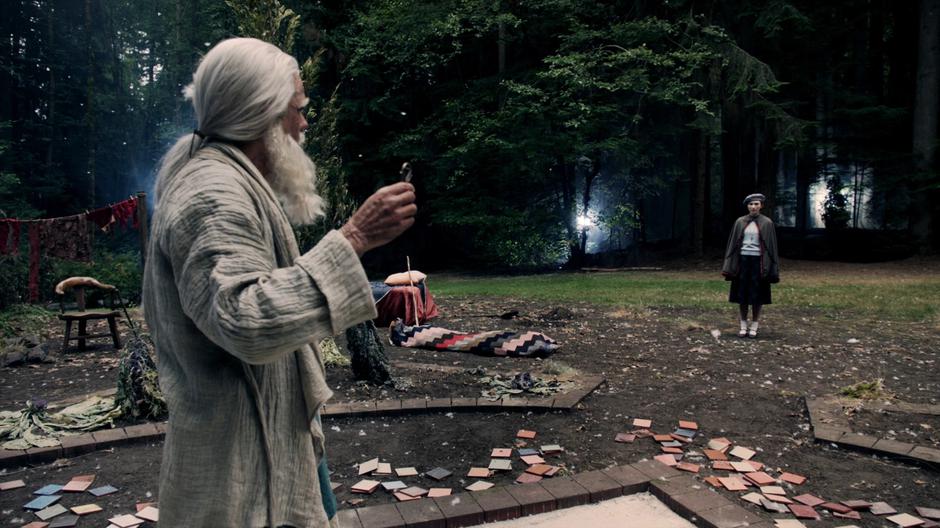 Elderly Quentin looks over at Jane Chatwin after getting the key.