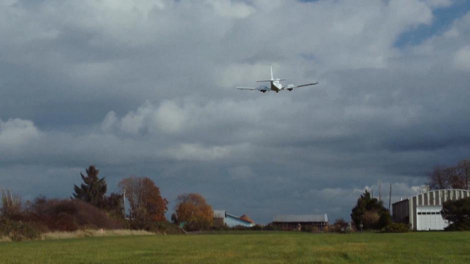 The crop duster takes off from the grass runway.