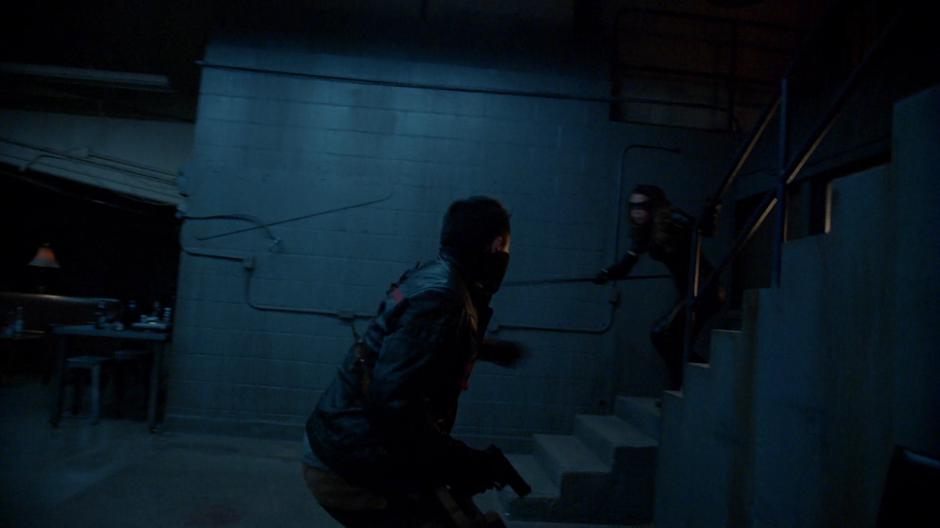 Dinah jumps down the stairs at one of the remaining guards.