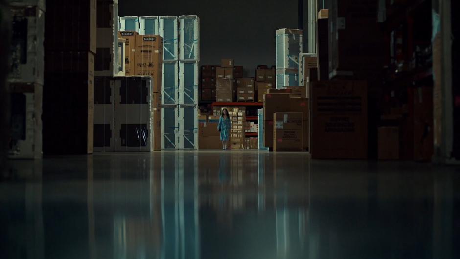 Mary walks through the empty warehouse.