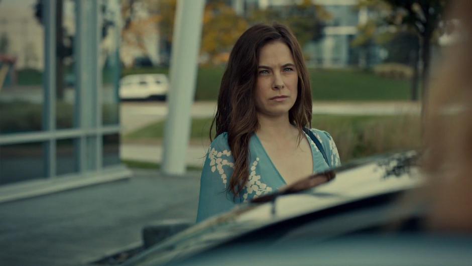 Mary gives Olivia a look across the top of the car.