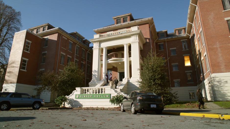 Daytime establishing shot of the front of the asylum.