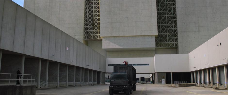 Peter lays down on top of a truck as it is leaving the facility.