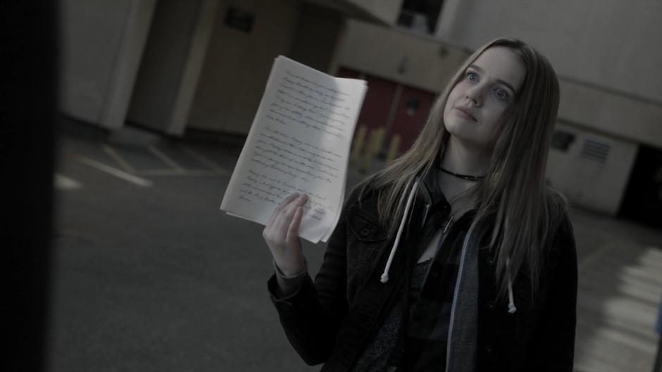 Sylvia holds up the oracle's writings to Penny.