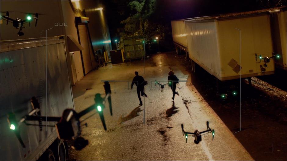 Mulder and Scully run away from a pack of drones.