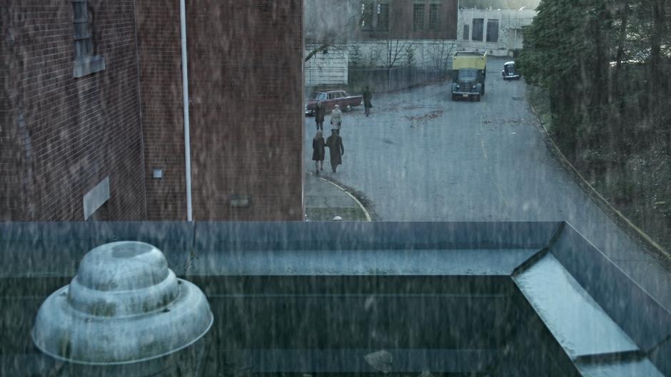 A truck drives down the road behind the building.