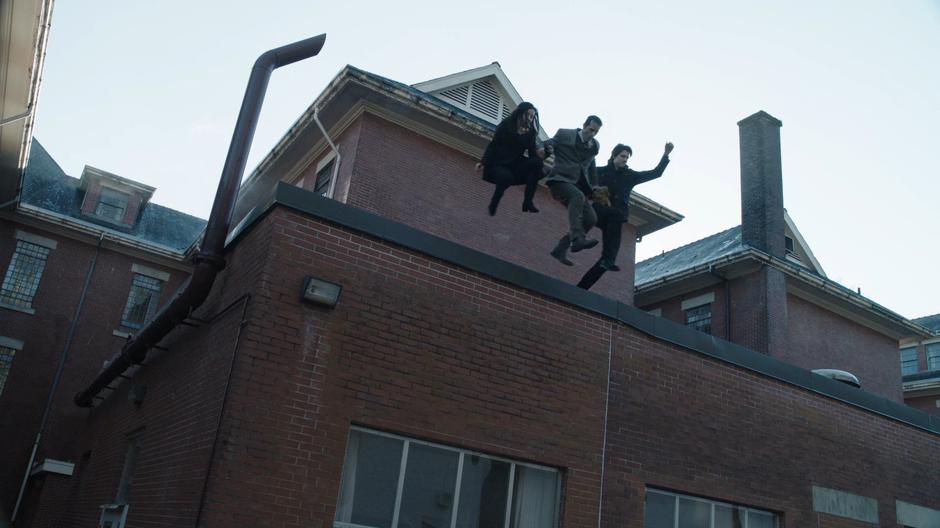 Nora, Dr. Vogal, and Ray leap off the building into the passing truck.