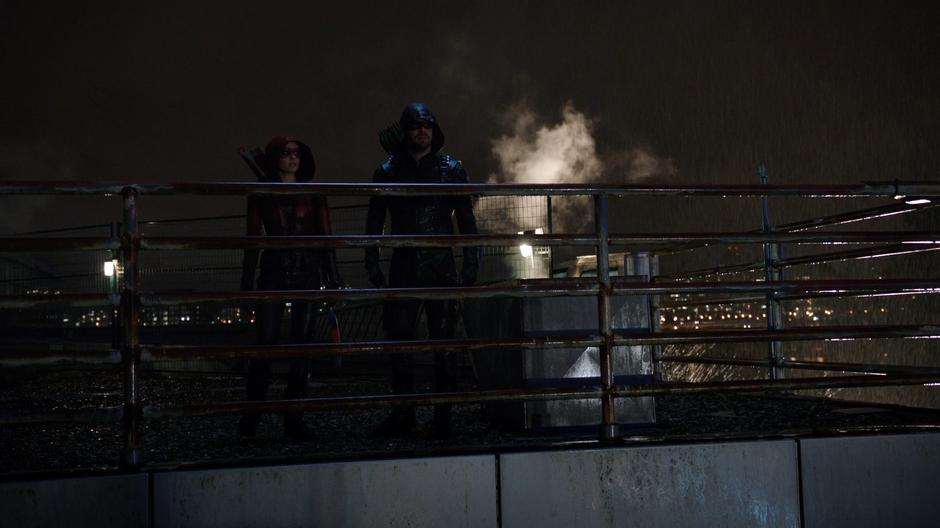 Thea and Oliver walk up to the edge of the roof.