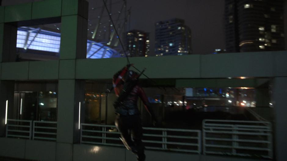 Thea slides down the line towards the hotel balcony.