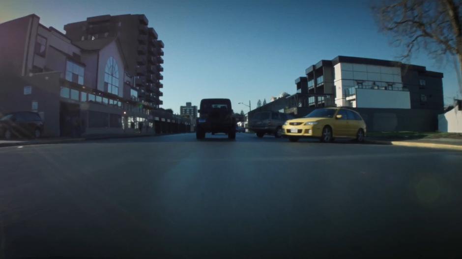 The squad car races through traffic in town.