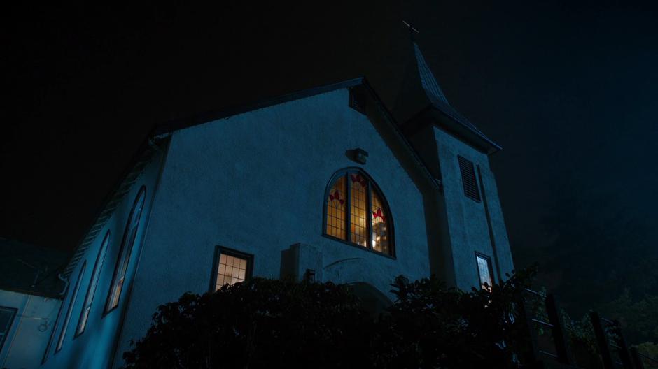 Nighttime establishing shot of the front of the church.