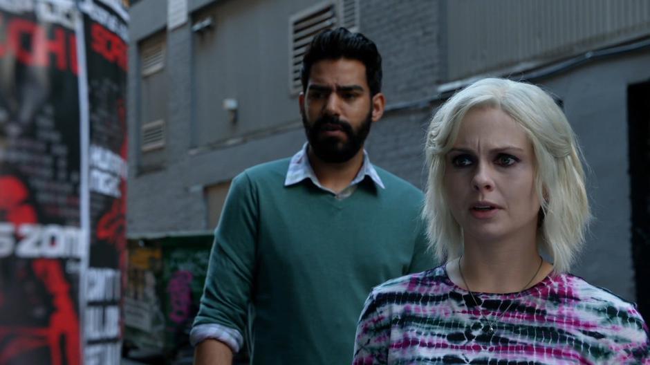 Ravi and Liv examine the flier advertising the Human vs Zombie night at the scratching post.