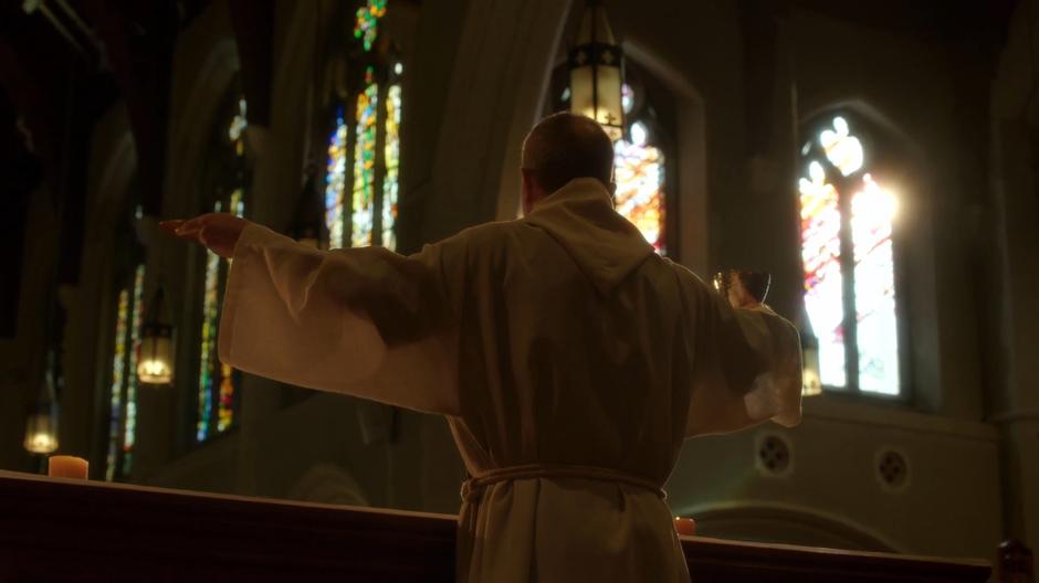 The priest guides the congregation through communion.