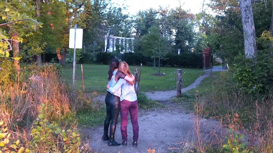 Carmilla and Laura hug after climbing out of the pit.