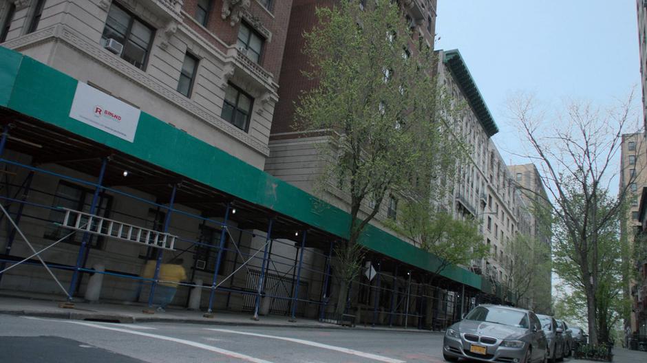 The Whizzer zips down the street under some construction scaffolding.