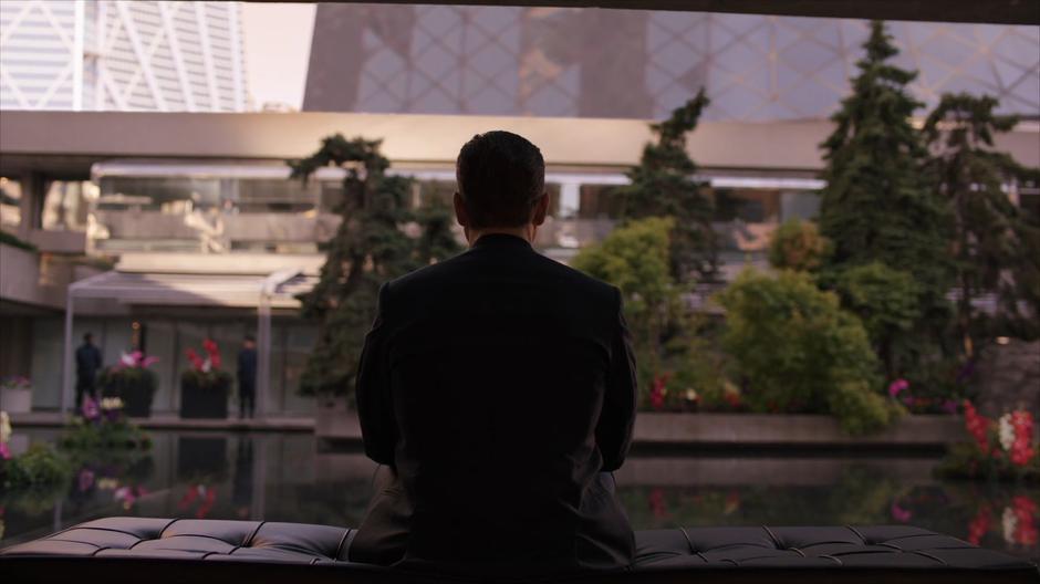 Errinwright sits on a bench looking out at the garden.