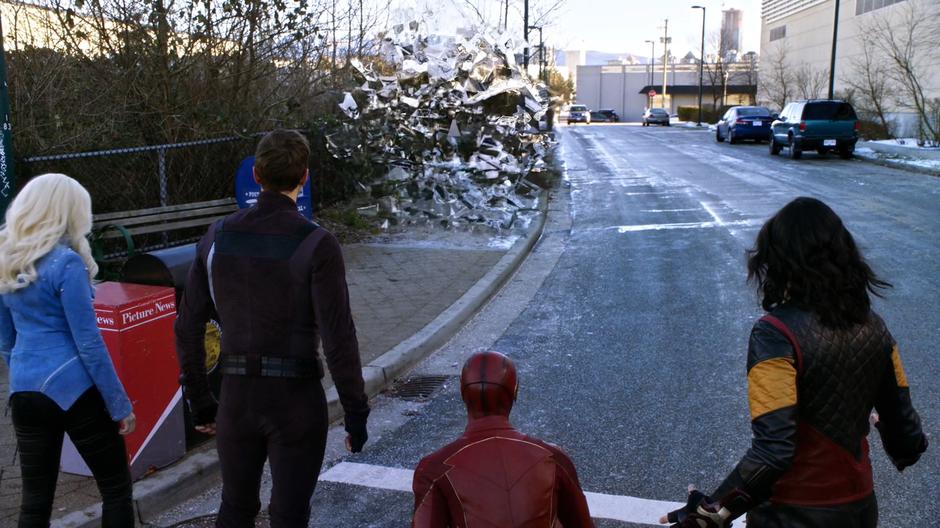 The four team members watch as the pocket universe opens.