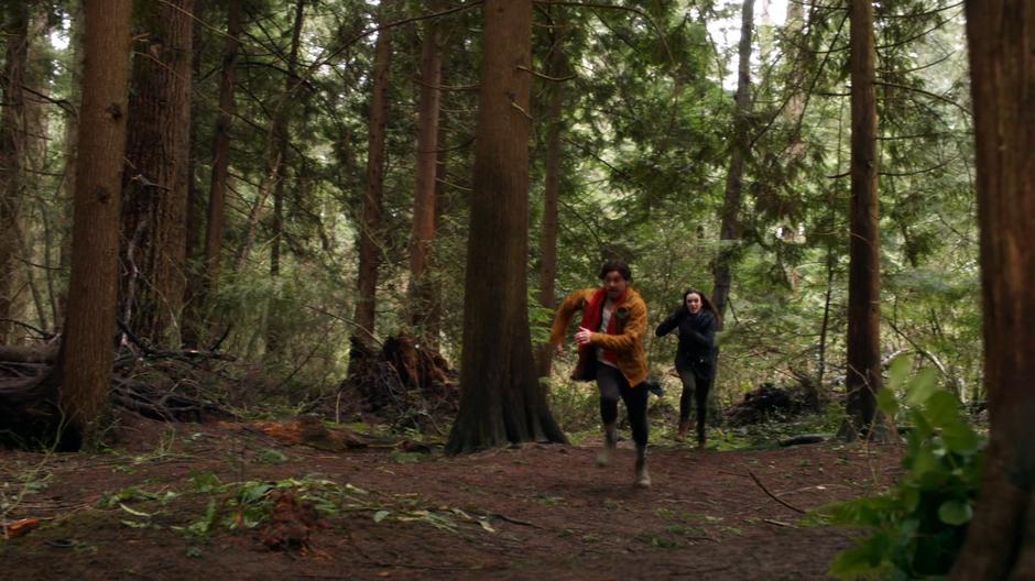 Caitlin chases Edwin Gauss through the woods.