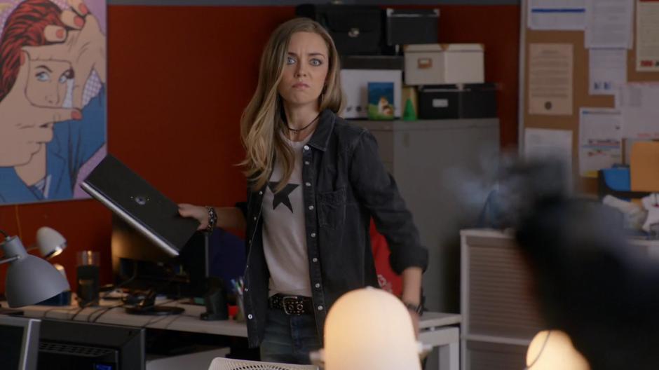 Rachel Greenblatt defiantly holds up her computer as Major shoots it.