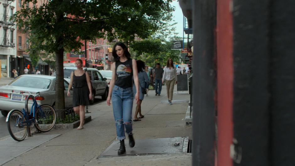 Alisa follows Jessica down the street and around the corner.