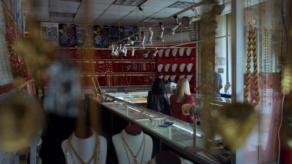 Jessica and Trish walk up to the desk as the employee prepares to show them the surveillance tape.