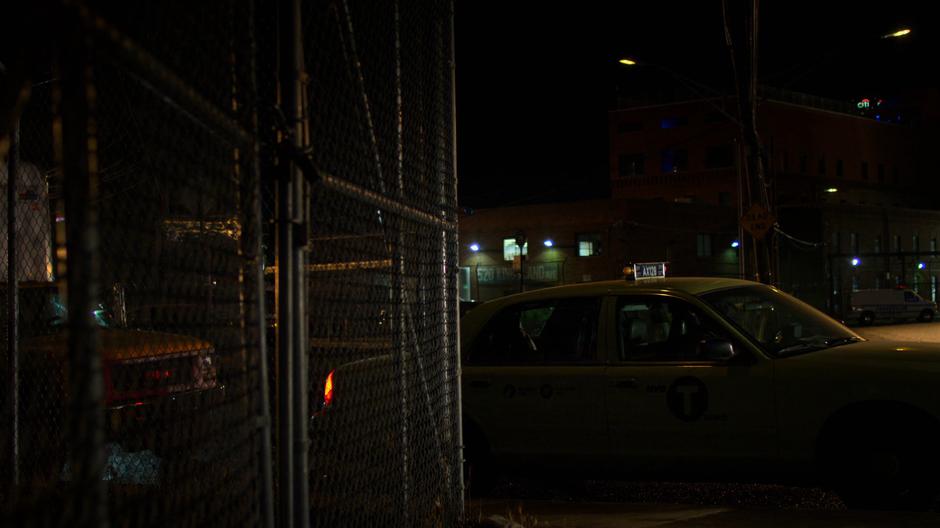 Jessica sits in a taxi waiting for Dale Holiday to leave work for the night.