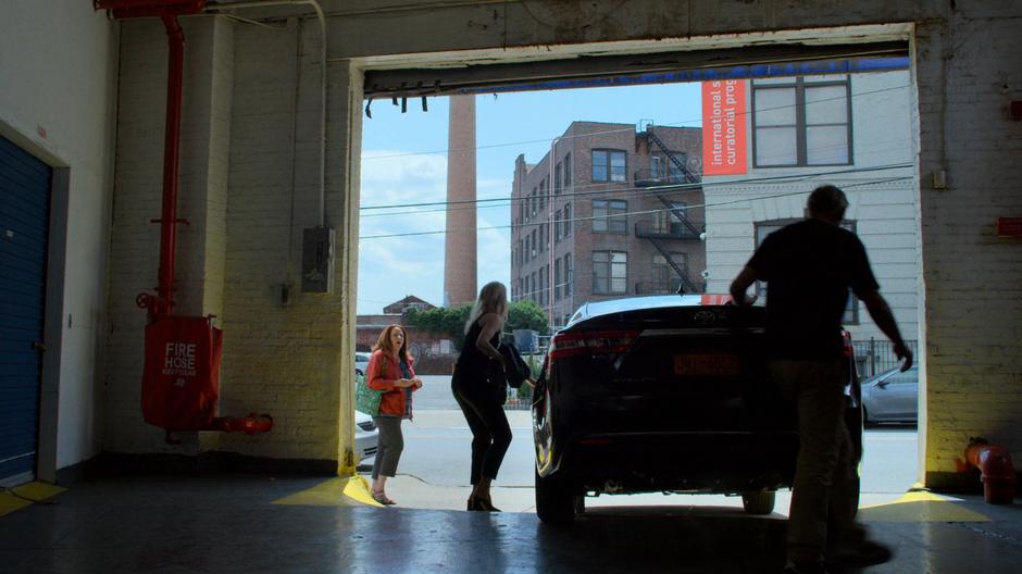 A fan notices Trish as she is getting into the car with Malus.