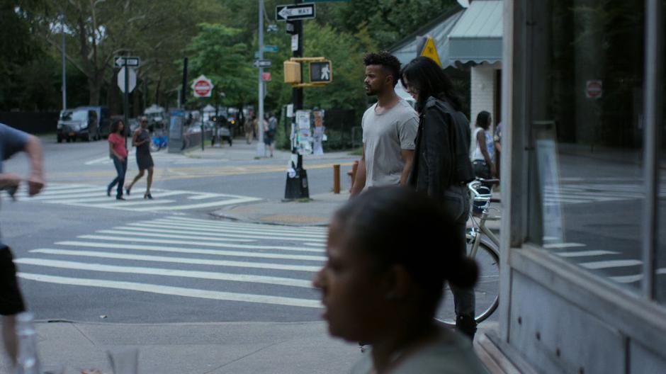 Malcolm and Jessica stop at the street corner.