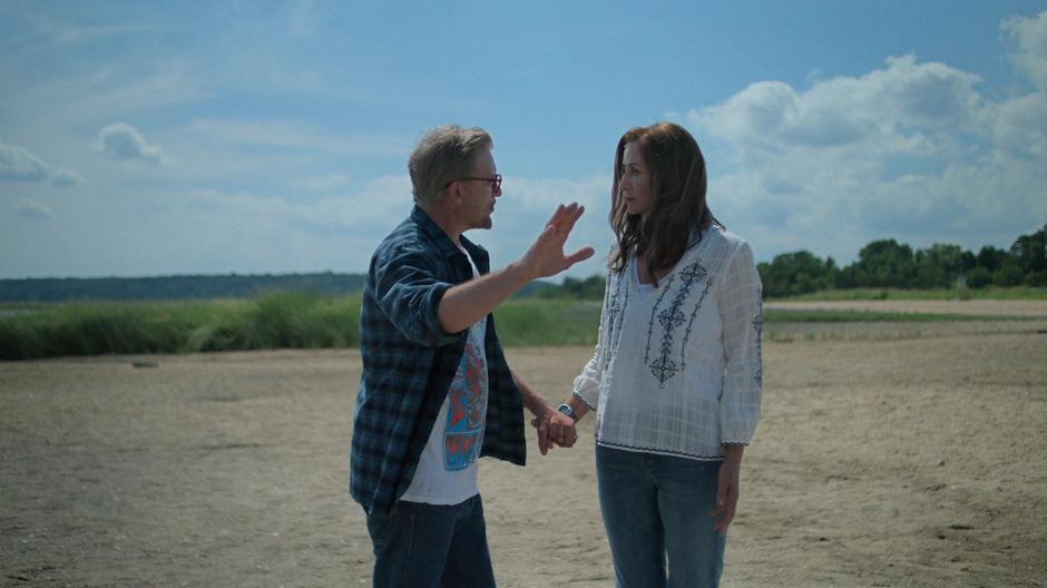 Malus motions out to the water while talking with Alisa.