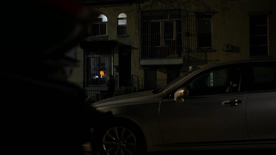 Hogarth watches as Inez goes across the street to the apartment.