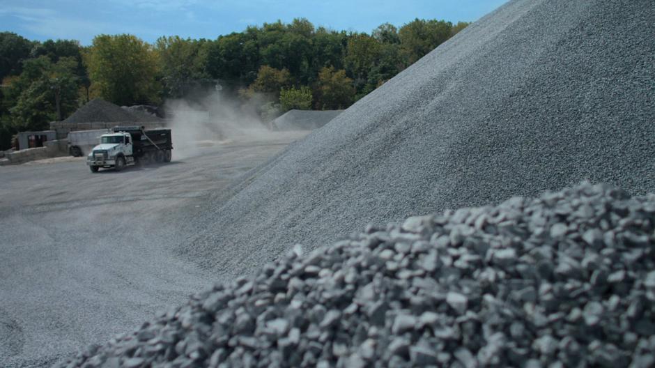 The truck that Jessica used to escape drives into the gravel pit.