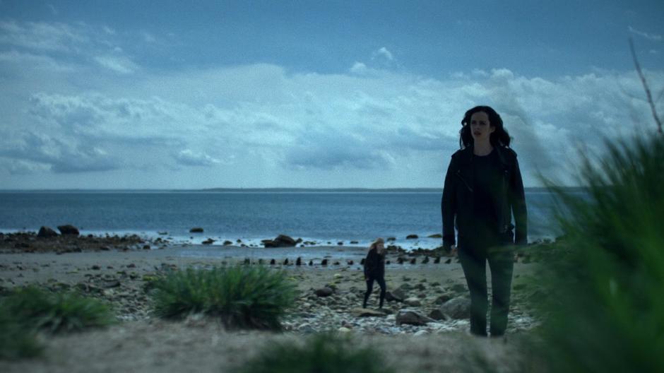 Trish and Jessica walk up the hill from the beach.