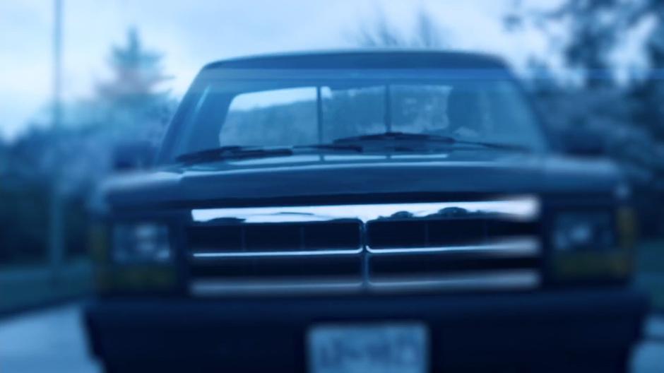 A truck sits stopped in the street in the memory.