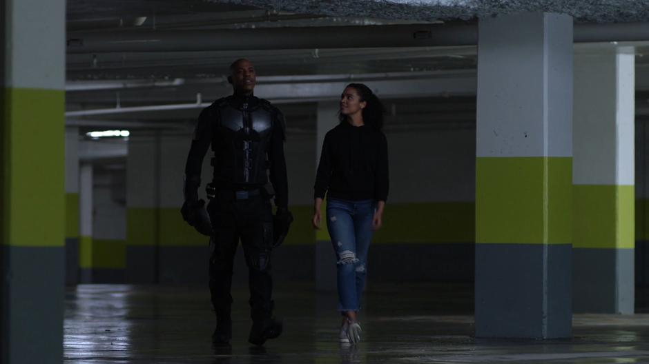 James and Tanya talk while walking through the garage.