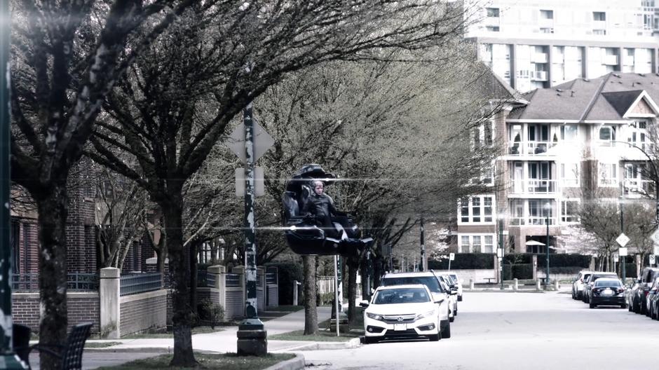 DeVoe floats down the street on his chair.