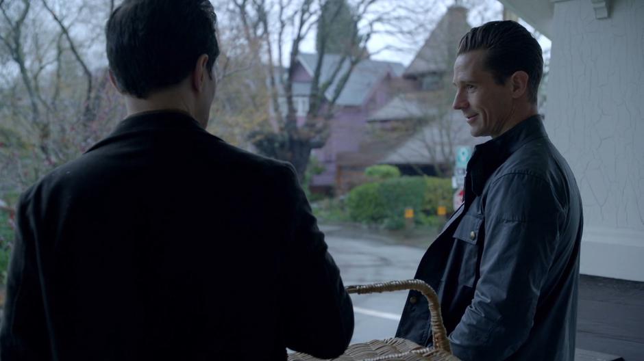 Chase Graves smiles while talking with Lambert on the porch.