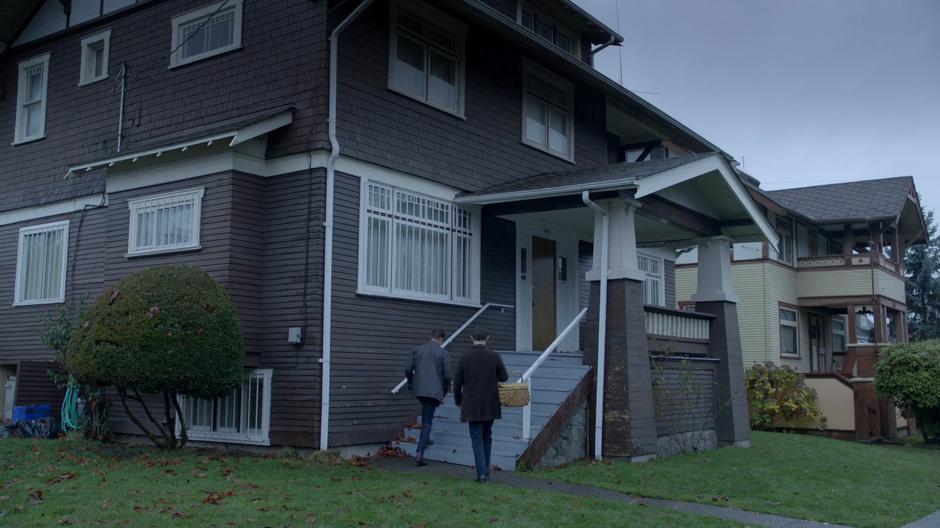 Chase Graves and Lambert walk up the steps to the front door of the house.