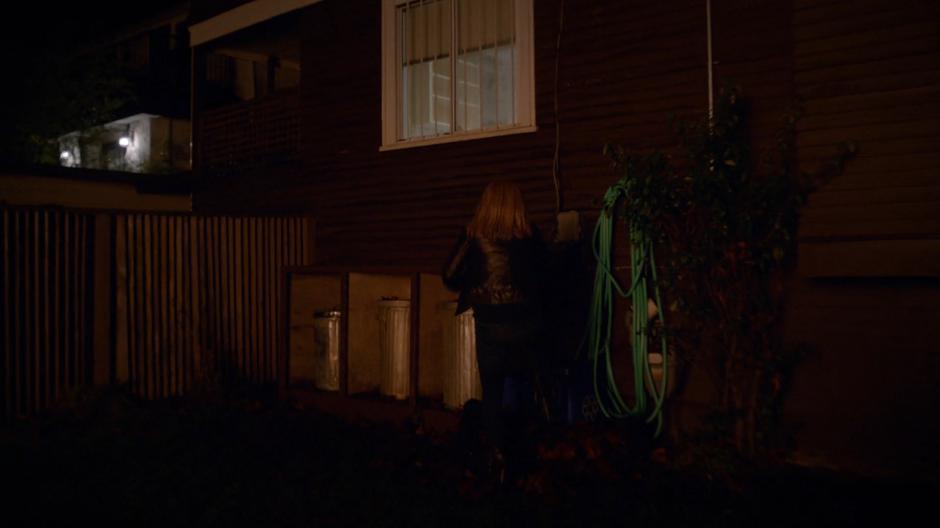 Liv runs across the lawn to the kitchen window.