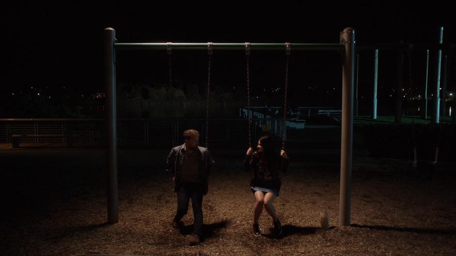 Shaun and Nina sit on the swingset talking about Shaun's dream.