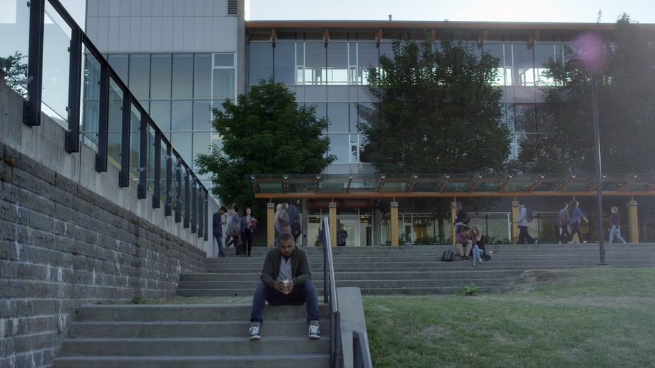 Nina walks down the path to where Andy is sitting on the steps.