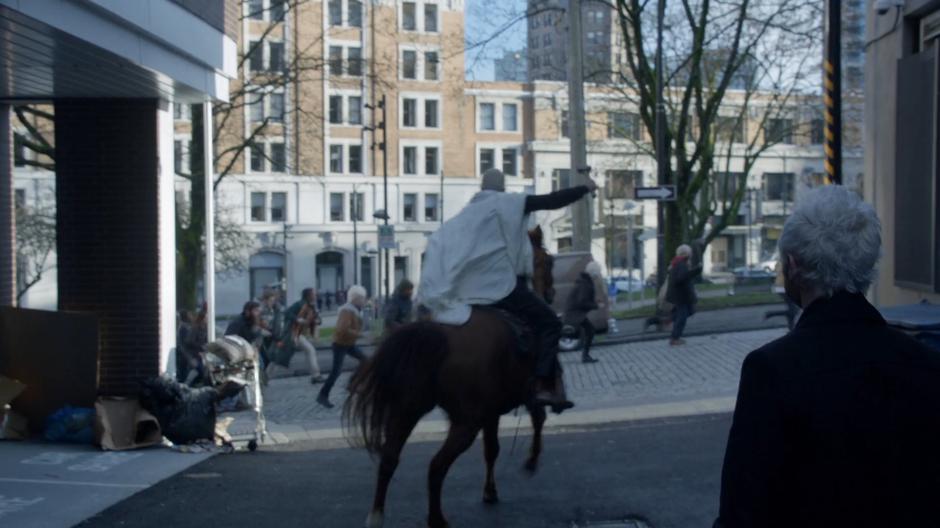 Angus rides off after his congregation on the stolen police horse while Blaine watches.