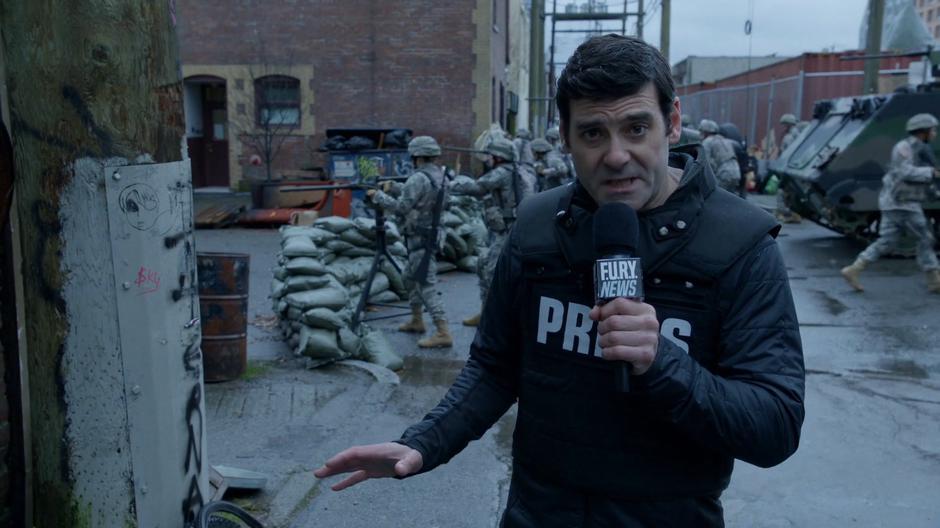 A reporter for F.U.R.Y. News tells the public about the military barricade set up at the point where the congregation is set to strike.